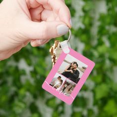 a person holding a keychain with a photo on it