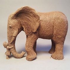 an elephant figurine made out of clay on a white background with no people around it