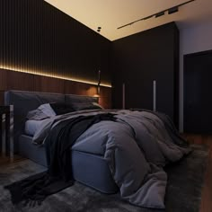 a large bed sitting on top of a wooden floor next to a night stand and lamp