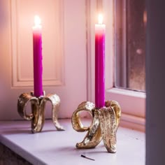 two candles are sitting on a window sill in front of the numbers 20 and twenty