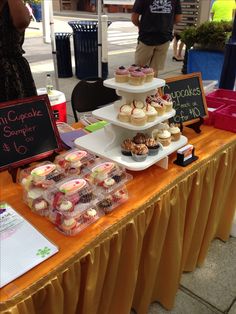 a table topped with lots of cupcakes and pastries