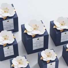 six blue boxes with white flowers on them