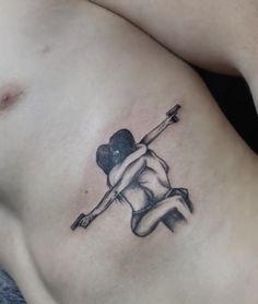 a man with a heart tattoo on his chest holding a bow and arrow in one hand