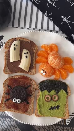 a white plate topped with slices of toast covered in fruit and veggie faces