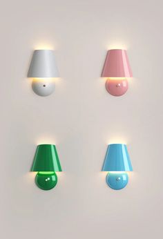 three different colored lamps are on the wall