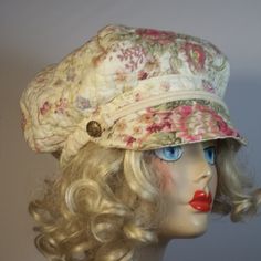 a mannequin head wearing a hat with flowers on it's brim