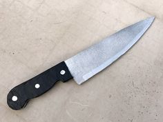 a large knife is laying on the ground