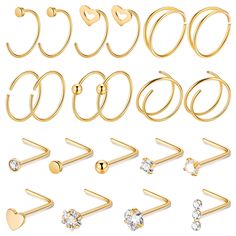 a set of 9 pairs of gold tone nose rings with heart and crystal stones on each side