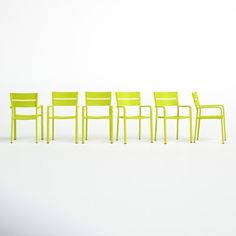 five yellow chairs are lined up against a white background, with one chair in the middle