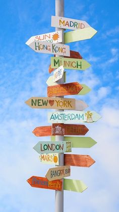 a sign post with many signs pointing in different directions