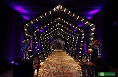 the inside of a building decorated with lights and rugs for a wedding or special event