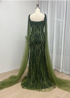 a dress on a mannequin in front of a window