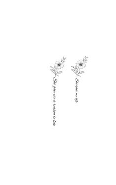 two white flowers are attached to the back of some silver earring posts with writing on them