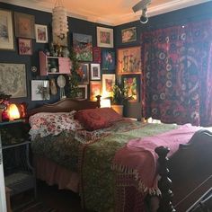 a bed room with a neatly made bed and lots of pictures on the wall above it