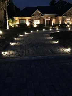 a driveway with some lights on it at night