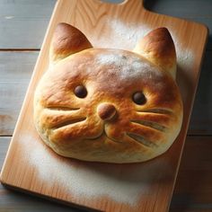 a bread shaped like a cat on a cutting board