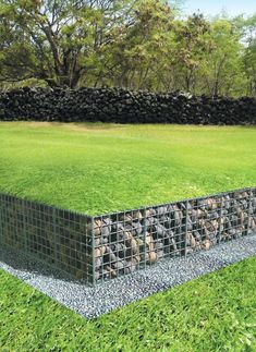 a large grassy field with rocks in the middle and grass growing on it's sides