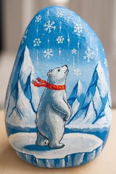 a painted rock with a polar bear on it