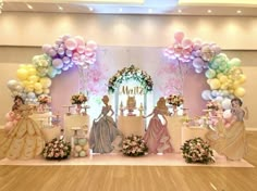 an elaborately decorated stage set up for a princess themed birthday party with balloons and decorations