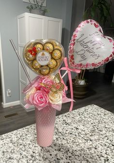 a vase filled with lots of chocolates and balloons