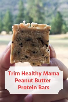 a hand holding up a peanut butter protein bar with the title trim healthy mama peanut butter protein bars