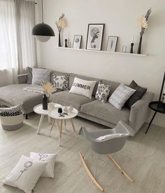 a living room filled with lots of furniture next to a wall mounted clock on the wall