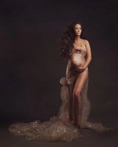 a pregnant woman posing for a photo in her belly and dress with sequins on it