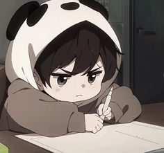 a person sitting at a table with a pen and paper in front of them, wearing a panda costume