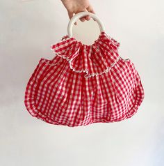 Vintage Red Gingham Cotton Bag. This charming piece features a ruffled top with decorative buttons, circular metallic handles, and a spacious interior. Made from a cotton fabric, it showcases a classic red and white vichy pattern. CONDITIONS Excellent Conditions DESCRIPTION No brand tag Material: Cotton (no composition label inside) Color: Red, White MEASUREMENTS  Height 36 cm (14") Length 52 cm (20.4") Drop 12 cm (4.7") measurements are taken seam to seam with the item laid flat (I suggest comp Cotton Tote Shoulder Bag For Picnic, Spring Picnic Cotton Bag, Cotton Summer Picnic Bag, Summer Cotton Bag For Picnic, Cotton Picnic Bag For Summer, Red Cotton Bag For Summer, Red Spring Picnic Bag, Red Cotton Double Handle Shoulder Bag, Red Double Handle Cotton Shoulder Bag