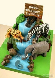 a birthday cake made to look like an elephant, zebra and giraffe drinking water