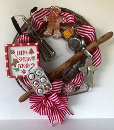 a wreath with baking utensils, cookies and other holiday items on it is displayed