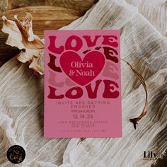 a pink card with the words love and noah on it next to a dried flower