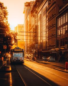 a trolley car is traveling down the street