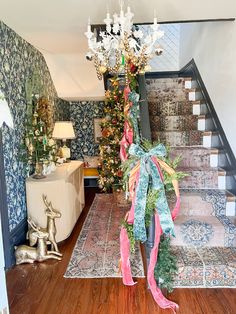 a staircase decorated with christmas decorations and ribbons