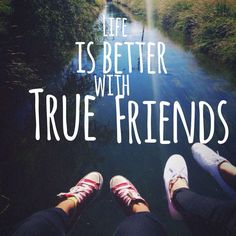 two people standing in front of a river with the words life is better with true friends