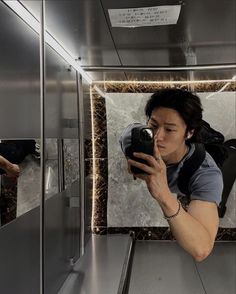 a man taking a selfie in front of a mirror