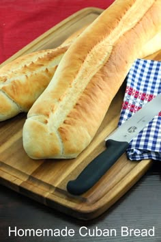 a loaf of bread sitting on top of a wooden cutting board next to a knife