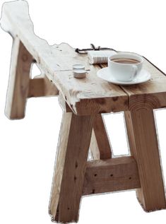 a wooden bench with a cup of coffee on it