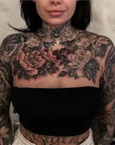 a woman with lots of tattoos on her chest