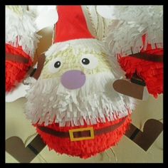 a santa clause pinata hanging from the ceiling