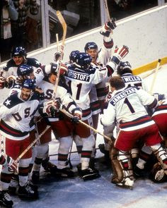 a group of hockey players huddle together on the ice