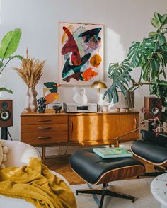 a living room filled with furniture and plants