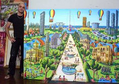 a man standing in front of a large painting with hot air balloons flying over the city