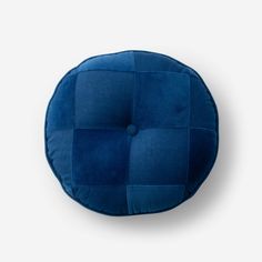 a blue round cushion on a white background