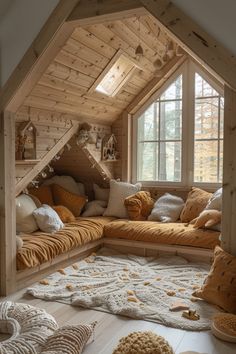 a living room filled with lots of pillows and blankets