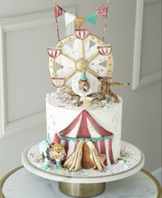 a carousel cake is decorated with animals and flags