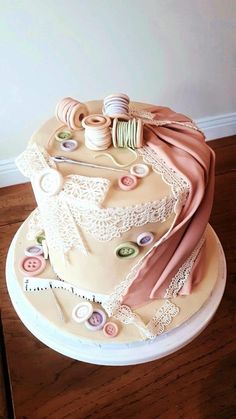 there is a cake that has many different things on it, including yarn and buttons