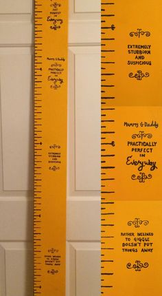 a tall yellow ruler sitting on top of a wooden floor