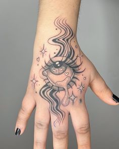 a person's hand with a tattoo on it