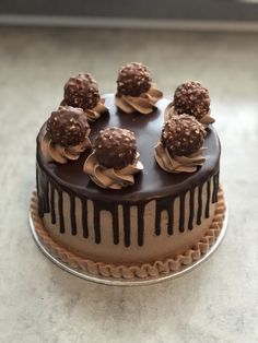 a cake with chocolate icing and frosting on top sitting on a countertop